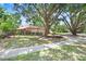 Charming single-story home featuring mature trees, a lush lawn, and attractive landscaping, providing great curb appeal at 107 Halton Cir, Seffner, FL 33584