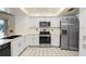 Modern kitchen featuring stainless steel appliances, white cabinets, and sleek countertops at 107 Halton Cir, Seffner, FL 33584