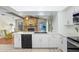 Well-lit kitchen with white cabinetry, stainless steel appliances, and an open layout to the living space at 107 Halton Cir, Seffner, FL 33584