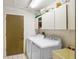 Laundry room with washer, dryer, storage cabinets and door at 107 Halton Cir, Seffner, FL 33584