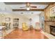 Cozy living room with a brick fireplace, ceiling fan, and exposed wood beams at 107 Halton Cir, Seffner, FL 33584