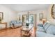Comfortable living room with hardwood floors and access to the outdoor pool area at 107 Halton Cir, Seffner, FL 33584