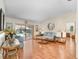 Spacious living room with hardwood floors and a view of the screened-in pool at 107 Halton Cir, Seffner, FL 33584