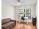 Bright office space with a desk, chair, and window overlooking the yard at 107 Halton Cir, Seffner, FL 33584