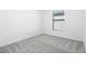 Cozy bedroom featuring neutral carpeting and a window for natural light at 11192 Humber Rd, Weeki Wachee, FL 34614