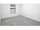 Cozy bedroom featuring neutral carpeting and a window for natural light at 11192 Humber Rd, Weeki Wachee, FL 34614