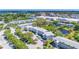 Aerial view of the complex showcasing mature trees and the nearby pond at 11224 82Nd Ave # 104, Seminole, FL 33772