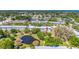 Aerial view highlighting the community's buildings surrounded by lush landscapes and a serene pond at 11224 82Nd Ave # 104, Seminole, FL 33772