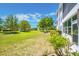 Grassy backyard showcasing the well-maintained lawn, landscaping, and building exterior at 11224 82Nd Ave # 104, Seminole, FL 33772