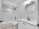 Clean bathroom featuring a tiled shower, tub, and a modern vanity with a round mirror at 11224 82Nd Ave # 104, Seminole, FL 33772