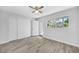 Spacious bedroom with wood-look floors, ample closet space, and bright natural light at 11224 82Nd Ave # 104, Seminole, FL 33772