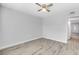 Empty bedroom featuring neutral walls, a ceiling fan, and luxury vinyl plank flooring at 11224 82Nd Ave # 104, Seminole, FL 33772