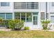 Exterior of a building with a sunroom, white door, and tropical plants at 11224 82Nd Ave # 104, Seminole, FL 33772
