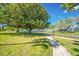 Picturesque greenspace with a walking path, mature trees, and community amenities at 11224 82Nd Ave # 104, Seminole, FL 33772