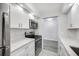 Modern kitchen with stainless steel appliances, white cabinets, and stylish countertops at 11224 82Nd Ave # 104, Seminole, FL 33772