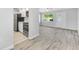 Open-concept layout with a view from the kitchen to the living area with natural light at 11224 82Nd Ave # 104, Seminole, FL 33772