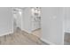 View from a hallway to a bright white kitchen, featuring stainless steel appliances at 11224 82Nd Ave # 104, Seminole, FL 33772