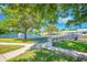 Picturesque pond with a fountain, surrounded by lush greenery and a charming bridge at 11224 82Nd Ave # 104, Seminole, FL 33772