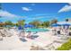 Community pool with lounge chairs and umbrellas for a relaxing outdoor experience at 11224 82Nd Ave # 104, Seminole, FL 33772