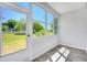 Bright sunroom with multiple windows offering scenic outdoor views and vinyl floors at 11224 82Nd Ave # 104, Seminole, FL 33772