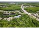 Aerial view of the homes, lake, highway and landscape in the community at 11723 Gothic Ln, Tampa, FL 33626