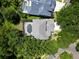 An aerial shot of a home with a screened-in pool, surrounded by mature trees at 11723 Gothic Ln, Tampa, FL 33626