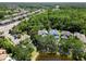 Areal view showcasing multiple homes near a lake with mature trees and lush landscaping at 11723 Gothic Ln, Tampa, FL 33626