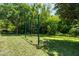 Serene backyard featuring a classic swing set and beautifully maintained lawn at 11723 Gothic Ln, Tampa, FL 33626