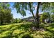 Expansive backyard showcasing a large screened-in pool area and mature trees at 11723 Gothic Ln, Tampa, FL 33626