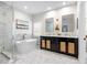 Luxurious bathroom with marble floors, freestanding tub, and dual vanity at 11723 Gothic Ln, Tampa, FL 33626