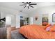 Bright bedroom with wood floors, ceiling fan, and ensuite bathroom at 11723 Gothic Ln, Tampa, FL 33626