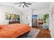 Spacious bedroom featuring an ensuite bathroom, ceiling fan, and hardwood floors at 11723 Gothic Ln, Tampa, FL 33626