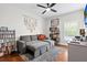 Cozy bedroom with sleeper sofa, wood floors, and a ceiling fan at 11723 Gothic Ln, Tampa, FL 33626