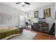 Comfortable bedroom with hardwood floors, bright windows, and space for work and play at 11723 Gothic Ln, Tampa, FL 33626