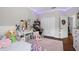 Bright bedroom featuring hardwood floors, closet, desk, and decorative led lights at 11723 Gothic Ln, Tampa, FL 33626