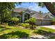 Stunning two-story home showcasing manicured landscaping and a three-car garage at 11723 Gothic Ln, Tampa, FL 33626