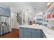 Bright kitchen features stainless steel appliances, blue cabinets, and marble countertops at 11723 Gothic Ln, Tampa, FL 33626