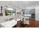 Stylish kitchen with marble counters, a built-in dining area, and modern lighting fixtures at 11723 Gothic Ln, Tampa, FL 33626