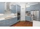 Modern kitchen equipped with stainless steel appliances, custom cabinetry, and a pantry at 11723 Gothic Ln, Tampa, FL 33626