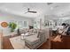 Bright living room features hardwood floors, stylish furnishings, and a seamless open layout to the kitchen at 11723 Gothic Ln, Tampa, FL 33626