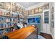 Charming office features built in bookshelves, decorative wallpaper, and a large wooden desk at 11723 Gothic Ln, Tampa, FL 33626