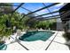 Beautiful screened-in pool surrounded by lush landscaping and ample patio space at 11723 Gothic Ln, Tampa, FL 33626