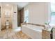 Bathroom features a soaking tub, travertine floors, and a separate shower at 118 S Manhattan Ave, Tampa, FL 33609