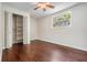 Empty bedroom with built-in shelves, wood floors, and a sunlit window at 118 S Manhattan Ave, Tampa, FL 33609