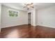 Spacious bedroom with wood floors, ceiling fan, closet, and ample natural light at 118 S Manhattan Ave, Tampa, FL 33609
