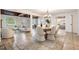 Open-concept dining room with stone floors and easy access to bedroom and living room at 118 S Manhattan Ave, Tampa, FL 33609