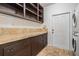 Laundry room featuring built-in cabinets, countertop space, and washer/dryer at 118 S Manhattan Ave, Tampa, FL 33609