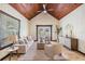 Inviting living room with vaulted wood ceiling, tile floors, and comfortable seating at 118 S Manhattan Ave, Tampa, FL 33609