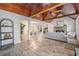 Open-concept living room with travertine floors, fireplace and access to dining area at 118 S Manhattan Ave, Tampa, FL 33609