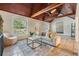 Comfortable living room with wood ceiling, travertine floors and natural light at 118 S Manhattan Ave, Tampa, FL 33609
